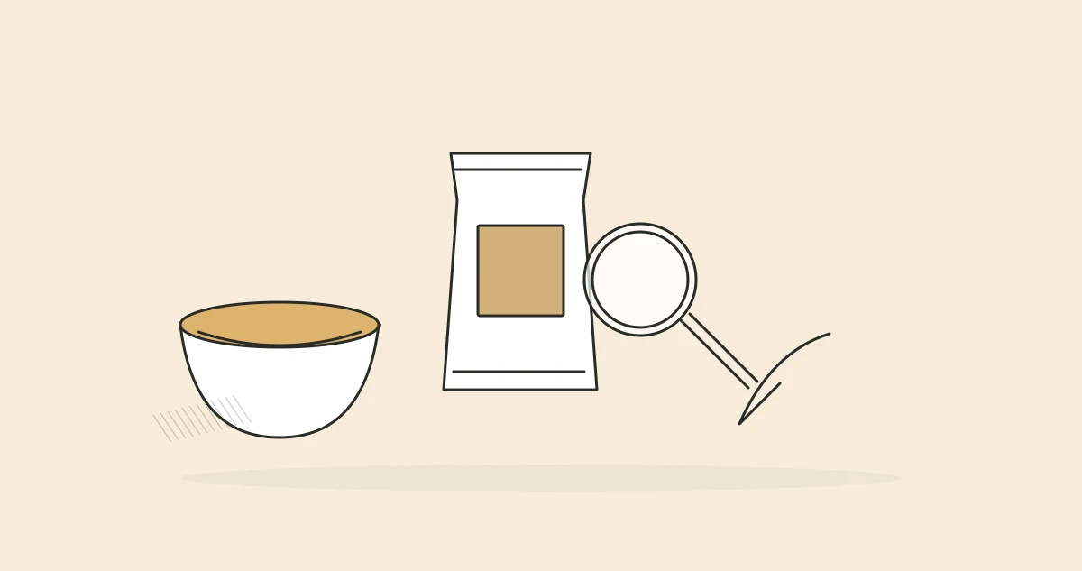 A magnifying glass over a food packet beside a bowl and spoon.
