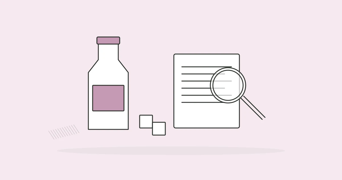 A drink bottle, sugar cubes and a nutrition panel under a lens.